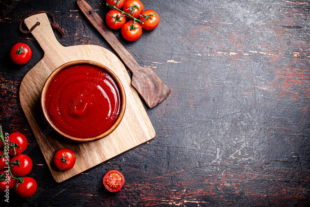 Wall mural tomato sauce on a wooden cutting board.