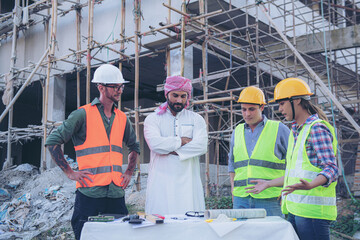 Engineering Consulting People on construction site holding blueprint in his hand. Building inspector. Construction site check drawing and business workflow of new building
