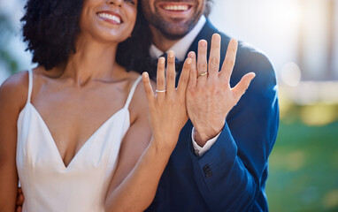Married couple, hands and wedding rings with smile for marriage, commitment or honeymoon in the...