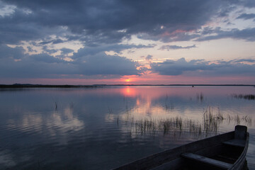 Floating in boat on lake landscape photo. Sunset. Beautiful nature scenery photography with skyline on background. Idyllic scene. High quality picture for wallpaper, travel blog, magazine, article