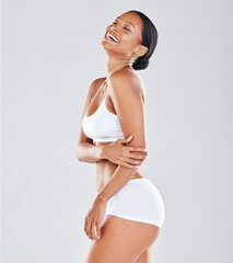 Fitness, skincare and black woman in underwear, smile and confident girl on grey studio background....