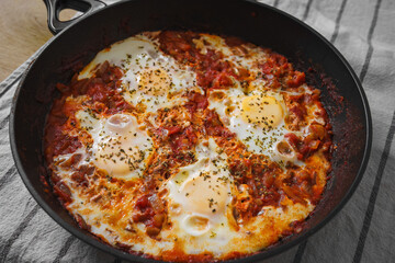 Home made Shakshuka, traditional North African and Middle Eastern dish on a pan