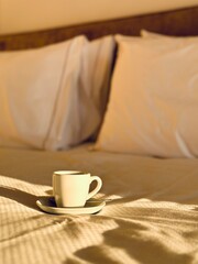 Fototapeta na wymiar cup of coffee on the bed