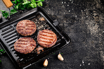Grilled burger in a frying pan. 