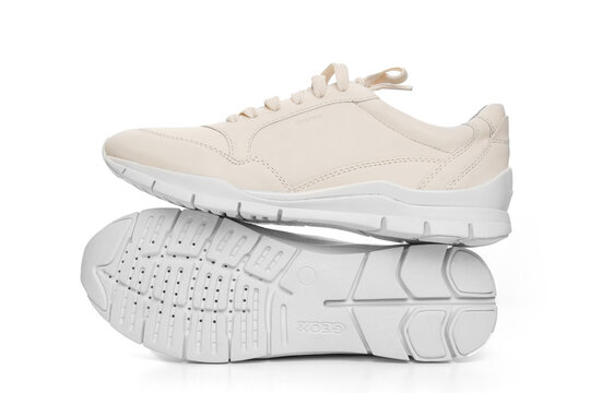 leather sneakers with lacing and perforated sole on a white background.
