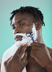 Shaving face with skincare cream, black man with razor on studio background and on smooth facial...