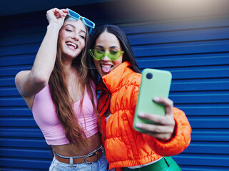 Fashion, selfie and friends with phone on blue background with style, cool sunglasses and urban...