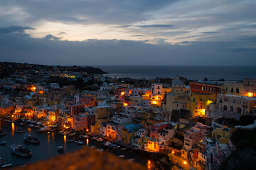 Fototapeta na wymiar Beautiful fishing village at night, Marina Corricella on Procida Island, Bay of Naples, Italy.