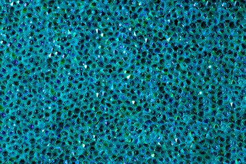Abstract rhinestones background. Texture of rhinestones illuminated with multi-colored light. Pink and blue shine diamonds. Close up. Flares on glass