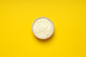 Concept of egg sauce, mayonnaise on yellow background