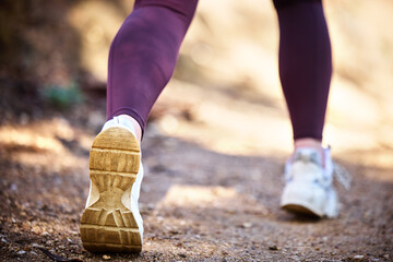 Running, health and shoes of woman in nature park for workout, fitness and cardio training. Wellness, sports and stamina endurance with girl runner jogging in forest for progress goals, exercise