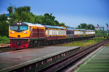 Naklejka premium Passenger train by diesel locomotive at the railway station. (Building is public)