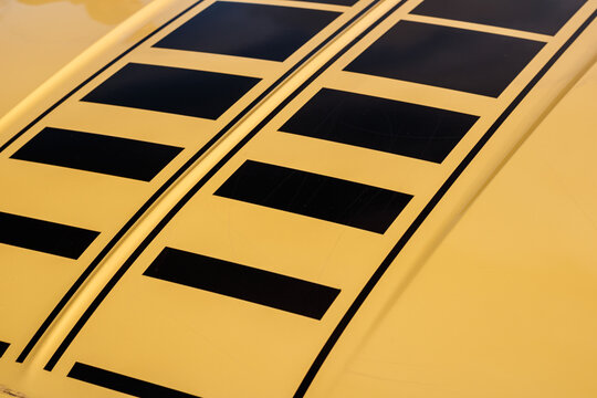 Close Up On A Vintage Car Hood Yellow And Black Line Pattern. 