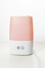 pink humidifier on a white background. device for home