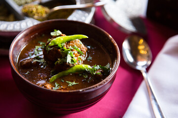 Korma, also qorma Kavurma or kurma, is a mild-flavored curry originating in India and Turkey, often made with yogurt sauce, heavy cream, or nuts.