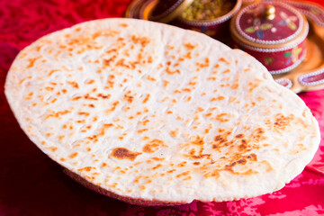 Naan is a flat bread, made from wheat flour and usually leavened. It is commonly consumed in several regions of Central Asia and South Asia: Afghanistan, Iran, Uzbekistan, Burma, Pakistan, and northwe