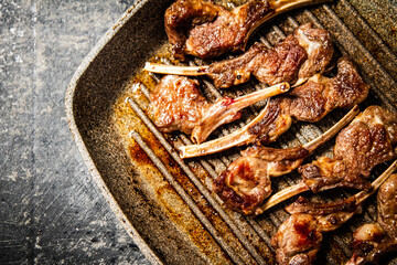 Fragrant grilled lamb rack on a stone board. 
