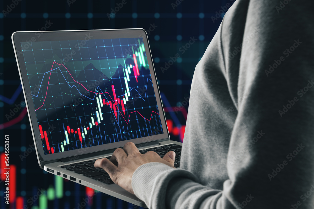 Poster close up of hacker hand using laptop with glowing forex chart on blurry dark grid background. trade,