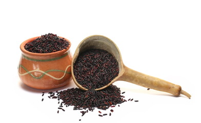 Black rice uncooked in clay pot, calabash isolated on white, side view