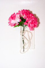 Transparent smartphone case with flowers and beads. copy space. isolated