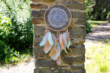 Fototapeta premium Handmade dream catcher with feathers threads and beads rope hanging