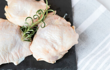 Raw chicken thighs. On a raw background. With various seasonings