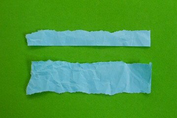 Set of blue torn paper on green background