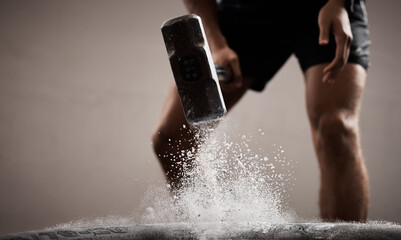 Workout, dust and hands hammer tire in studio isolated on a brown background mockup. Sports, fitness and male, athlete or man hammering tyre with chalk powder for training, exercise and muscle power.
