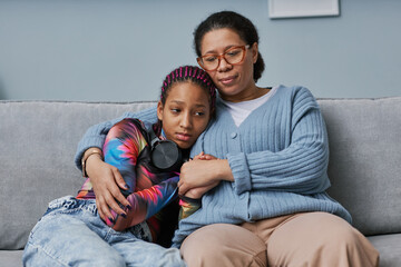 Black woman embracing teenage daughter