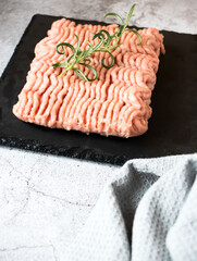 Raw minced meat with herbs and spices. on gray background