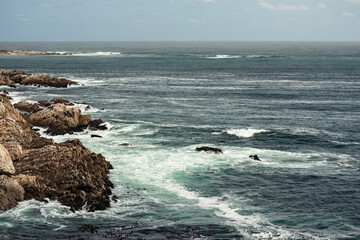Waves crashing over rocky coastline