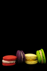 coloured macaroon pastries arranged next to each other horizontally