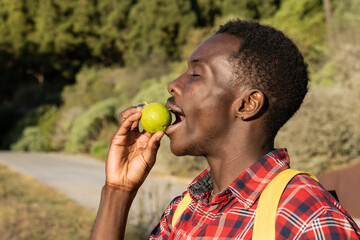 Portrait of a young man on vacation with a lemon in his mouth on the island of La Palma, Canary Islands (Spain).