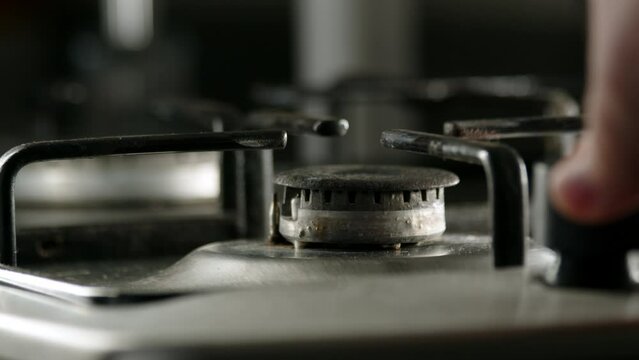 close up view of old gas stove, fire starts to burn. concept of cooking on gas stove in kitchen in morning. Warming up food.