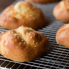 A close up of homemade ketogenic hamburger buns on a cooling rack.