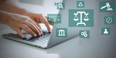 Naklejka na ściany i meble Legal business concept. Labor law, Lawyer, Online legal advice, Hand of human with legal services icon on laptop screen.