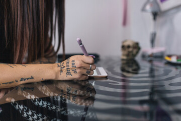 Tattoo artist hands designing a tattoo on her tablet. Digital tattoo design