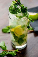 Mojito cocktail. Traditional Cuban punch. Cocktail is made with white rum, sugar, lime juice, soda water, and mint. Summer drink with rum, citrus, and herbaceous mint.