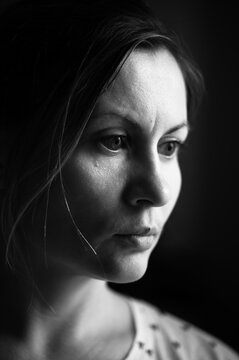 Monochrome portrait of a woman with light from the window, portrait of a young man.