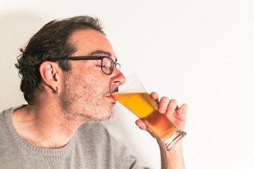 man drinking a glass of beer