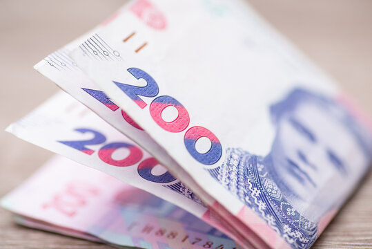 Macro image of ukrainian 200 hryvnia banknotes, cash concept. Focus on the numbers of money bills, portrait of famous poetess Lesya Ukrainka
