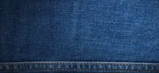 texture of blue jeans denim fabric with seam background