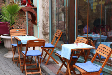 Fototapeta na wymiar selective focus: nostalgia tables and chairs of cafes in old historical streets in istanbul balat