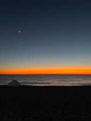 Tent on the beach at sunset and moon