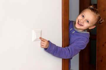 Switch off Light. Child Learns to  Turn off lights and Save Energy at home. Energy saving, Helping...