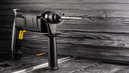 Power hammer drill stands on a table in a workshop