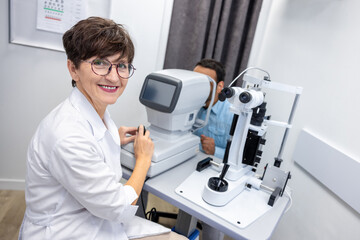 Optometrist in white scubs near refractometer