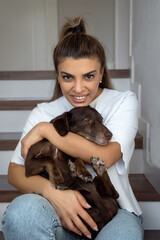 Brazilian Woman Embrace Her Favorite Pet Dog Dachshund Breed. Concept Of Friendship With Pet, Care, Veterinarian Health Wellbeing Animal. Vertical