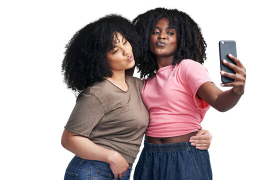 PNG Studio shot of two young women using a smartphone to take selfies