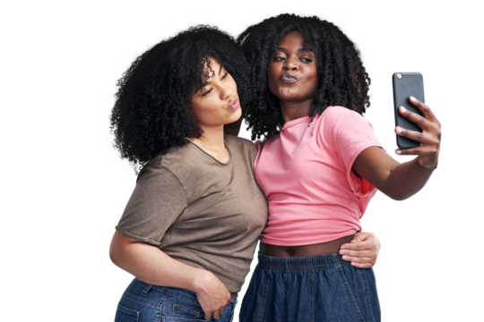 PNG Studio shot of two young women using a smartphone to take selfies
